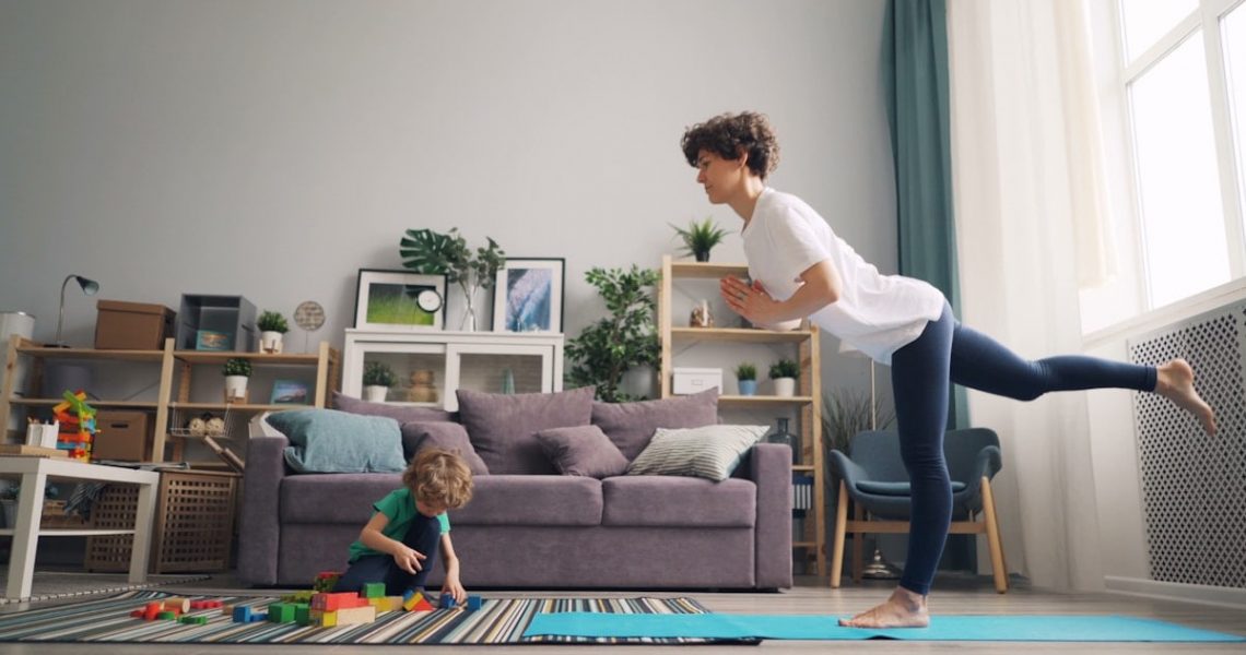 a woman and a child playing in a living room